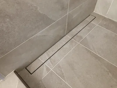 Custom Shower w/ Linear Drain, Corner Bench, and Feature Band Details 1
