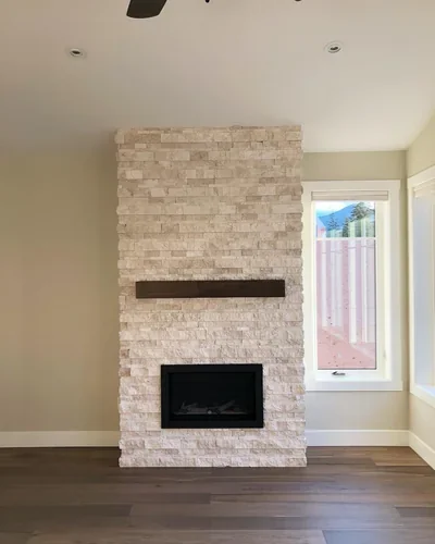 Floor-to-ceiling stone fireplace Installation