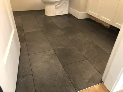 Dark large-format tile floor Installation