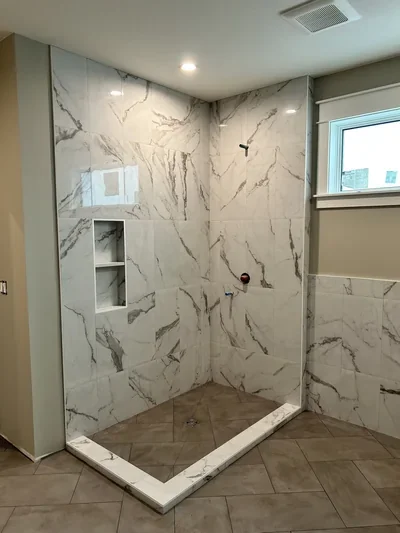 Custom tile shower with herringbone floor Installation